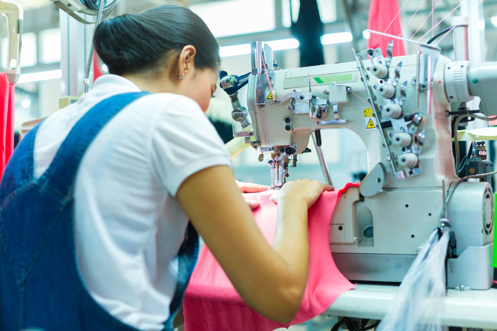 Indonesian seamstress in a textile factory