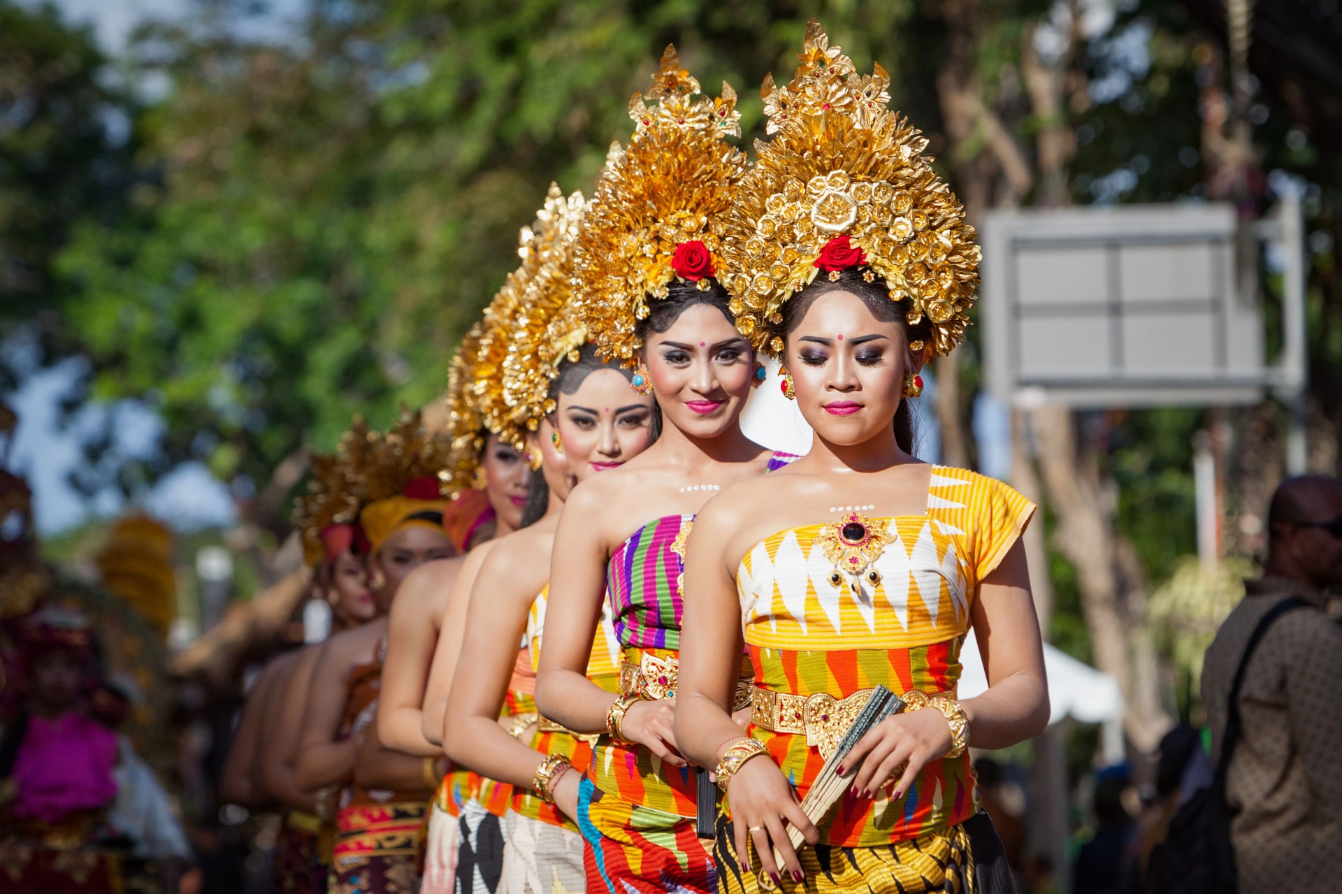 Procession of Balinese women in traditional sarongs carrying religious offering